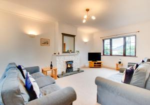 a living room with two couches and a fireplace at Dirleton in Saundersfoot