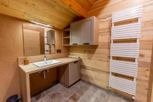 a bathroom with a sink and a mirror at La Grange aux écureuils in Montagnole +64 photos