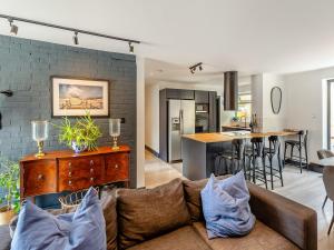 a living room with a couch and a kitchen at Seabrook House in Hythe