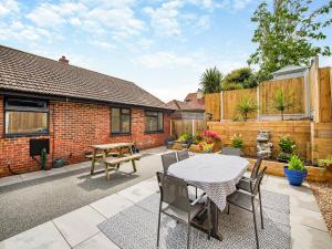 a patio with a table and chairs at Seabrook House in Hythe