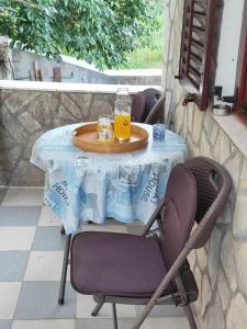 a table with a blue table cloth and drinks on it at Dragana in Basina