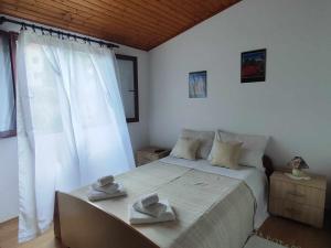 a bedroom with a bed with two hats on it at Dragana in Basina