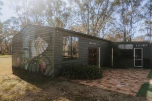 a tiny house with a painting on the side of it at Tiny House 14 at Grampians Edge in Dadswells Bridge