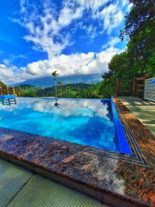 a swimming pool with a view of the sky at Chalona Hill View in Munnar