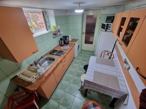 a small kitchen with a sink and a table at MRI Residence in Cluj-Napoca