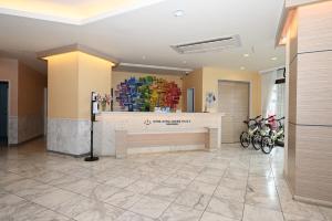 a lobby with a counter with bikes parked around it at Hotel Royal Marine Palace Ishigakijima in Ishigaki Island