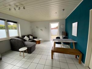 a living room with a couch and a table at Ferienwohnung Currle in Wangerland