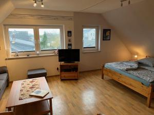 a bedroom with a bed and a tv in it at Ferienwohnung Currle in Wangerland