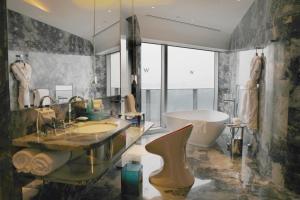 La salle de bains est pourvue d'une baignoire, d'un lavabo et d'une baignoire. dans l'établissement W XIAN Hotel, à Xi'an