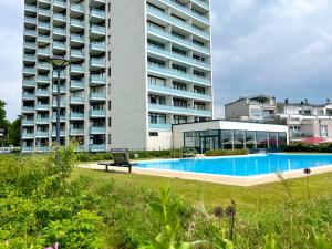 a large building with a swimming pool in front of a building at Prinz Hamlet "Godewind" in Pelzerhaken