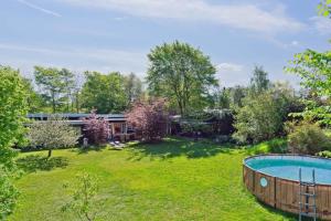 a yard with a pool and a house at Spacious Summer House With Pool in Vejby +18 photos