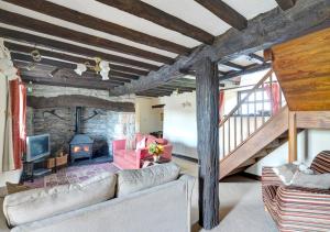 ein Wohnzimmer mit einem Sofa und einem Kamin in der Unterkunft Hendy in Gwaynynog
