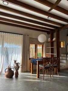 a dining room with a wooden table and chairs at Makai Medewi in Airsatang
