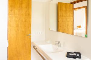 a bathroom with a sink and a mirror at Apartamentos Verde Mar in Es Pujols +116 photos