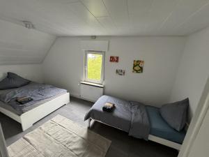 a bedroom with two beds and a window at Ferienhaus Am Südwall, 220qm in Medebach