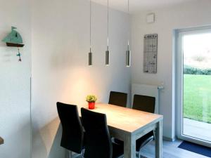 a dining room with a table and chairs at Ferienhaus 6969 in Tossens in Tossens
