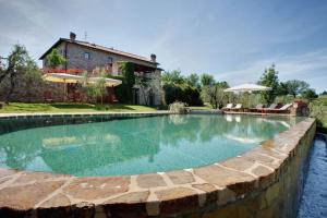 a swimming pool in front of a house at Villa Il Conventino in Mercatale Val Di Pesa