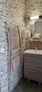 a bathroom with a towel rack next to a sink at Le Faubourg in Figeac