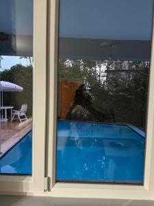 a window with a view of a swimming pool at Villaras Garden özel havuzlu eşyalı in Altınkum