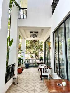 an outdoor patio with tables and chairs and windows at Memoire Siem Reap Hotel in Siem Reap