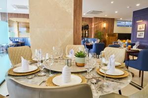 a dining room with a table with glasses and napkins at Shulem Boutique Hotel in Dimāpur