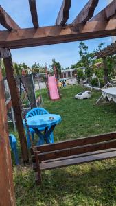 a park with a picnic table and a playground at Guest House Chalakov in Sinemorets