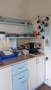 a kitchen with white cabinets and plates on the shelves at Guest House Chalakov in Sinemorets