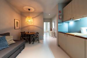 a kitchen and living room with a table and a couch at Marias River Apartment in Porto