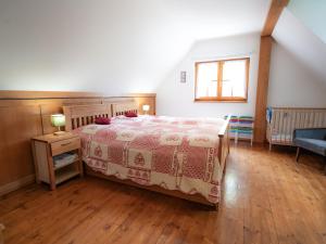 a bedroom with a bed and a wooden floor at Drevenička v Ďurčinej - Anna in Ďurčiná