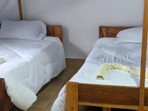 two beds sitting next to each other in a room at STC.SAFARI LODGE in Oldeani