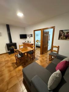 a living room with a couch and a table at Las Vistas in Bubión