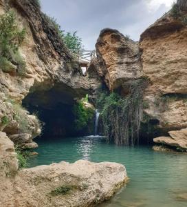 a pool of water in a canyon with a waterfall at Casa de la Orden La Quintaesencia de Bullas in Bullas