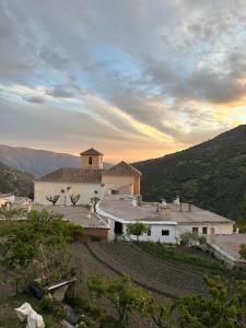 a large white building on top of a hill at Las Vistas in Bubión