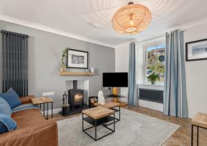 a living room with a couch and a fireplace at Enfield House in Saundersfoot