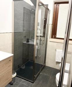 a shower with a glass door in a bathroom at LUX APARTMENT CAPANNELLE in Rome