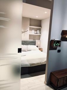 a bedroom with a bed and a mirror at LUX APARTMENT CAPANNELLE in Rome