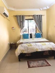 una camera con un grande letto e una finestra di CBA Hotel a Tanga