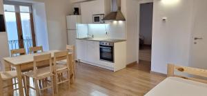 a kitchen and dining room with a table and a table and chairs at Cal Vallverdú 1I in Preixana