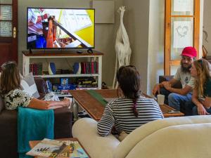 a group of people sitting in a living room at Midlands Forest Lodge in Balgowan
