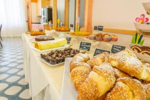 a buffet of pastries and desserts on a table at Hotel Vannucci in Rimini