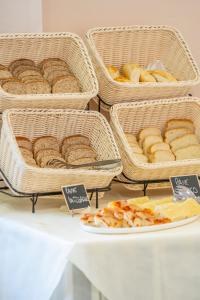 a table with baskets of bread and a plate of food at Hotel Vannucci in Rimini