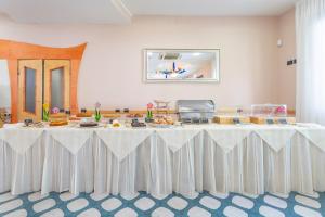 a large white table with food on top of it at Hotel Vannucci in Rimini