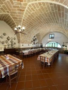 a large room with tables and chairs in a building at Masseria Scianne in Sant'Isidoro