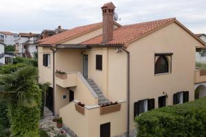 a house with a staircase in front of it at Apartments Mirella in Novigrad Istria