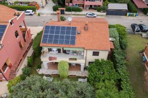 an aerial view of a house with solar panels on its roof at Apartments Mirella in Novigrad Istria