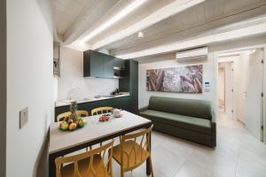 a kitchen and living room with a table and chairs at Dimora Guidi Tordini in Grottammare