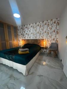 a bedroom with a bed and a chair in it at l'evasion ,maison de ville jacuzzi couchages x6 in Le Grau-du-Roi