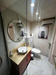 a bathroom with a sink and a mirror at l'evasion ,maison de ville jacuzzi couchages x6 in Le Grau-du-Roi
