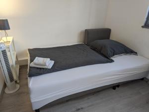 a bed with two pillows on it in a room at Lovely studio with free parking on premisis in Asten