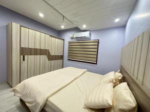 a bedroom with a bed in a room at TAJ ELEGANCE Luxury Service Apartment in Bhatkal
